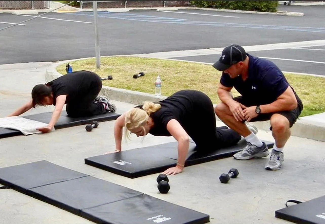 Personal trainer coaching clients outdoors in Ladera Ranch