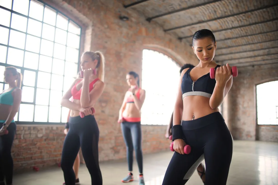 Women exercising with dumbbells together